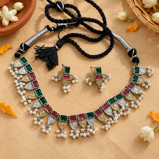 Anu Multicolour dual-tone necklace set with green and pink stones, pearl cluster drops, black dori closure, and matching earrings displayed for festive and ethnic wear.