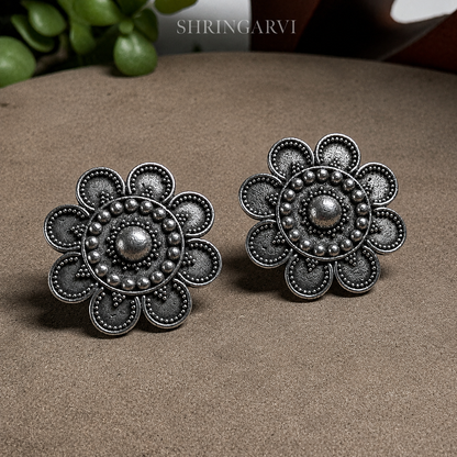 Bindiya Brass Oxidised Stud Earrings for Women featuring an intricate bindi-inspired floral design in antique silver finish by Shringarvi
