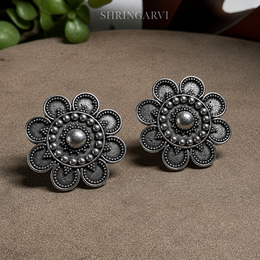 Bindiya Brass Oxidised Stud Earrings for Women featuring an intricate bindi-inspired floral design in antique silver finish by Shringarvi