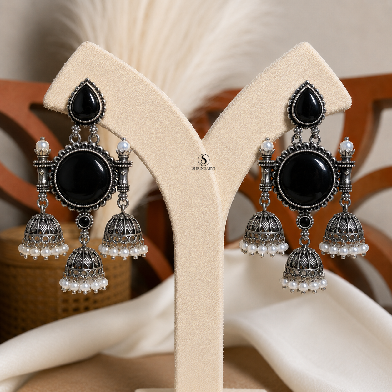 Black Monalisa Tripuri Jhumkas handcrafted in oxidised brass featuring Black Monalisa stones, pearl-adorned jhumkas, and intricate traditional detailing for festive and ethnic wear.