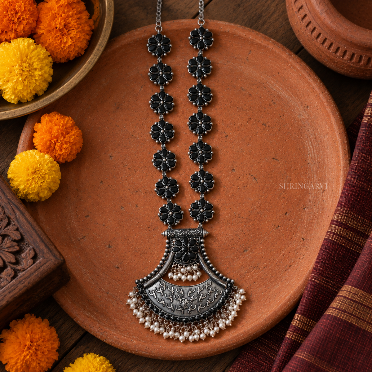 Black floral oxidised long necklace with statement engraved pendant and bead detailing. Perfect ethnic jewellery for handloom sarees and kurtas.