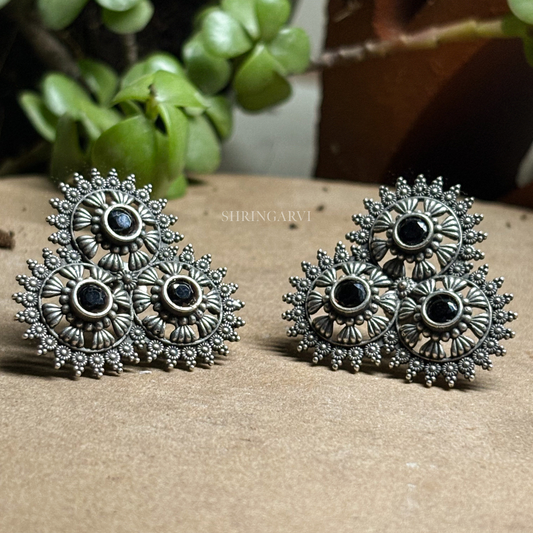 Shop Surya Studs by Shringarvi. Handcrafted oxidised brass stud earrings with a traditional floral-inspired design and black stone detailing. Perfect for daily wear, office wear, and ethnic outfits.