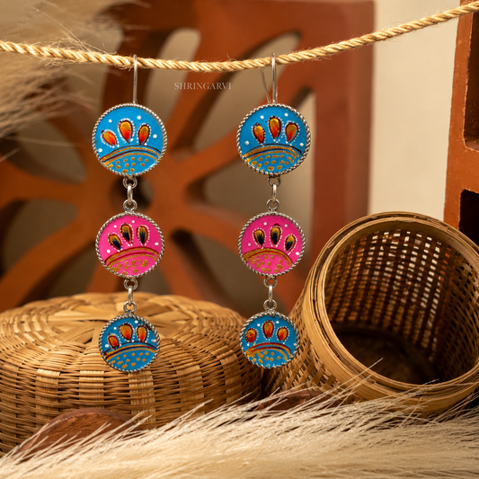 Blue Pink Kyari Danglers in oxidised brass with handpainted blue and pink enamel detailing and three-tier boho design.