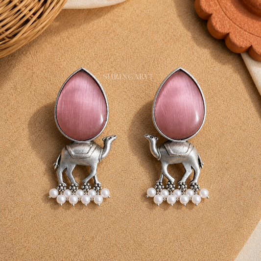 Handcrafted Blush Pink Monalisa Camel Danglers in oxidised brass featuring teardrop Blush Pink Monalisa stones, detailed camel motifs, and pearl drop accents for festive and ethnic styling.