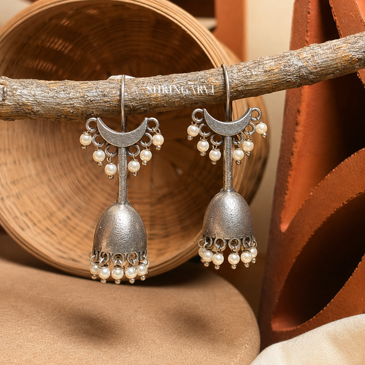 Chandraghanta Pearl Jhumka with crescent moon motif, oxidised silver finish, and pearl drop detailing for ethnic and everyday wear.