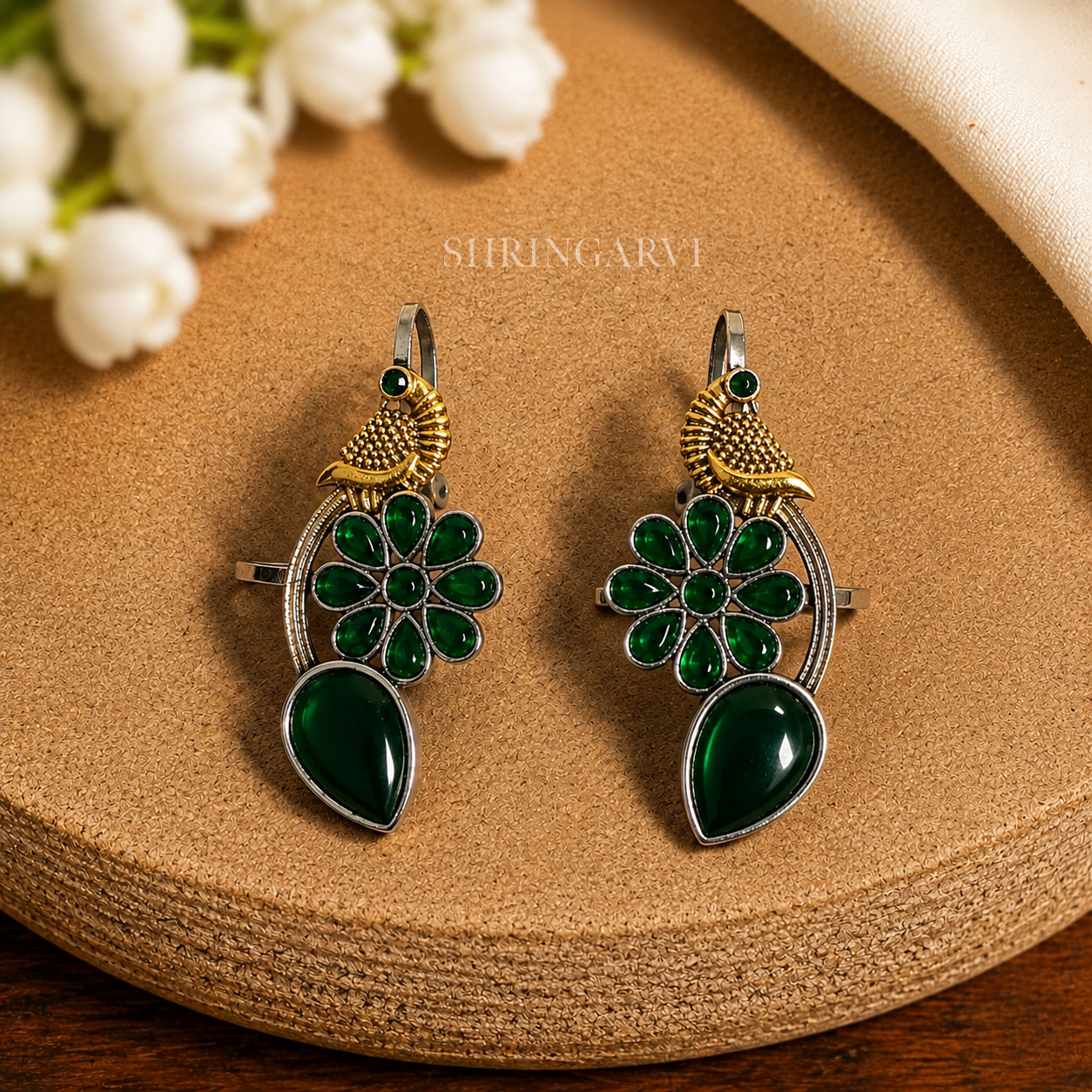 Emerald Green Meenakshi dual tone brass earcuffs with emerald green stones and peacock motif by Shringarvi.