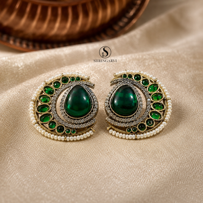 Emerald Green Nisha oxidised brass studs with an emerald green Monalisa stone, moissanite, AD stones, pearl border, and green accent stones by Shringarvi.