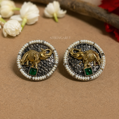 Oxidised brass Emerald Vinayak studs with antique gold elephant motif, emerald stone and pearl border by Shringarvi