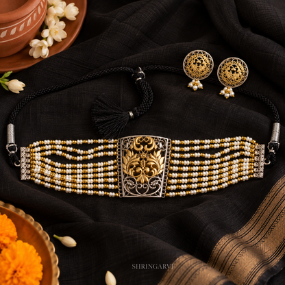 Gauri Dual Tone Pearl Choker Set with oxidised silver and gold-tone floral centerpiece, pearl bead strands, adjustable black dori closure, and matching pearl drop stud earrings