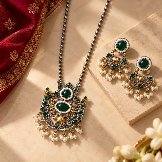 Emerald Megha oxidised necklace set with green stones, pearl detailing, and matching earrings for festive and ethnic wear.