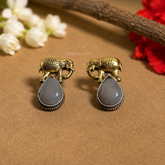 Grey Girija dual tone oxidised brass studs with antique gold elephant motif and glossy grey Monalisa stone by Shringarvi.
