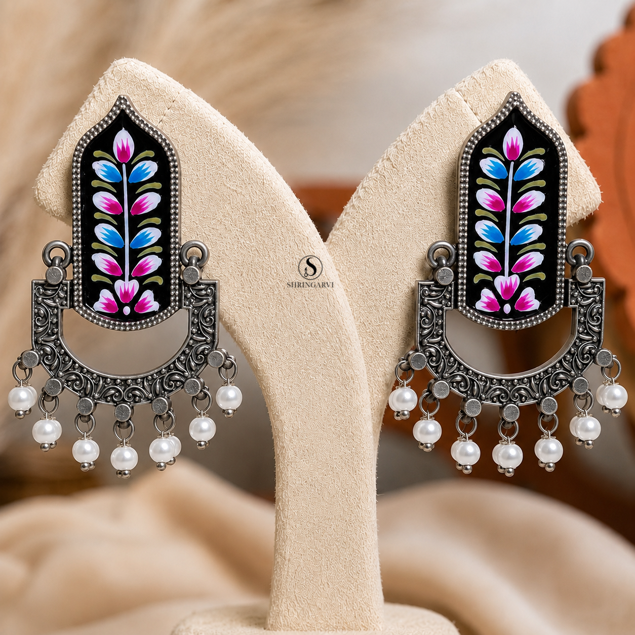 Handcrafted Black Handpainted Mangala Danglers in oxidised brass featuring colourful Meenakari floral artwork, intricate filigree detailing, and pearl drop accents for festive and ethnic styling.