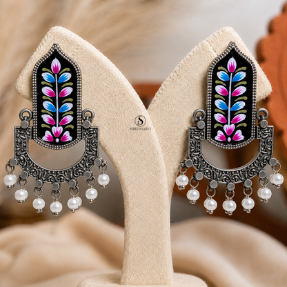 Handcrafted Black Handpainted Mangala Danglers in oxidised brass featuring colourful Meenakari floral artwork, intricate filigree detailing, and pearl drop accents for festive and ethnic styling.