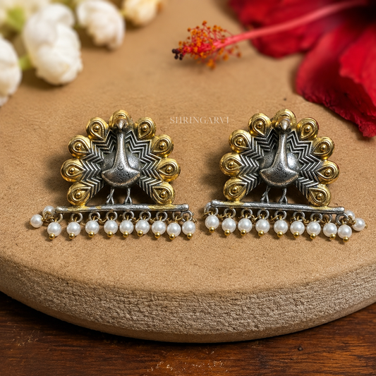 Dual-tone oxidised brass Mayuri studs with peacock motif and pearl drops by Shringarvi