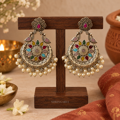 Multicolour Mohini Chandbali earrings with oxidised finish, colourful monalisa stone detailing, floral stud top, crescent design, and pearl drops for festive and everyday ethnic wear.