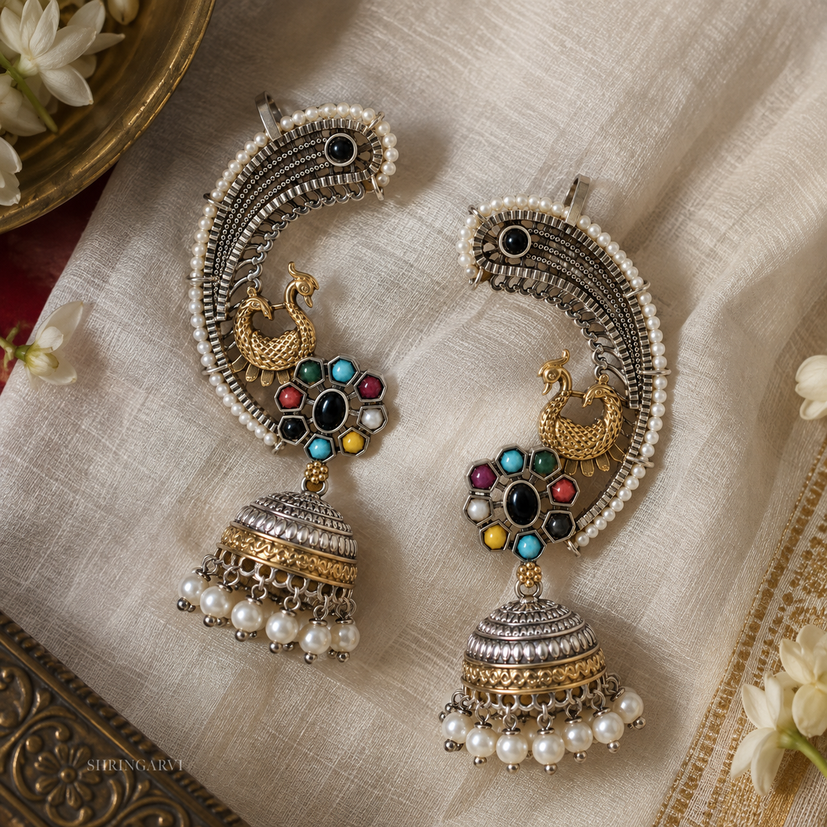 Multicolour Rajnigandha dual tone peacock earcuffs with colourful stones, pearl detailing and jhumka drop for Navratri and festive wear.