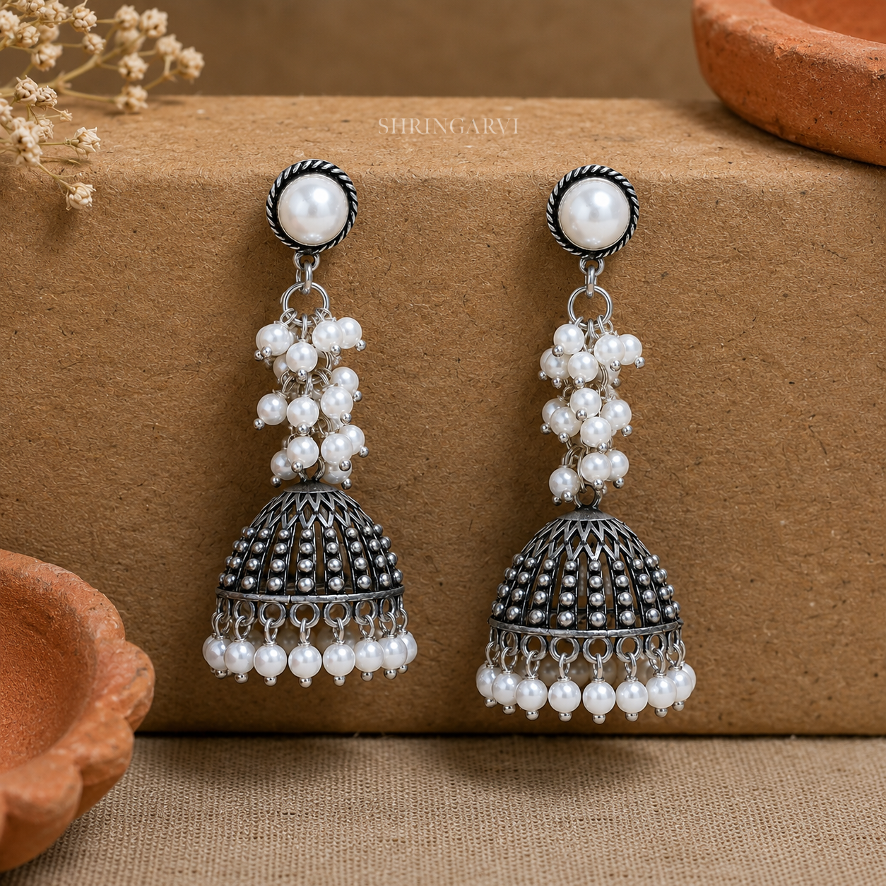 Oxidised brass pearl jhumka earrings with pearl cluster detailing