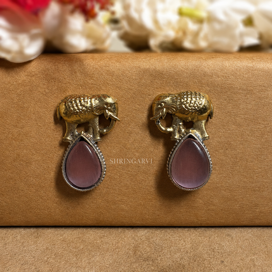 Pink Girija dual tone oxidised brass studs with antique gold elephant motif and glossy pink Monalisa stone by Shringarvi.