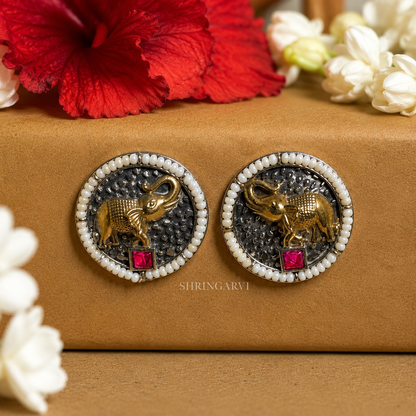Oxidised brass Ruby Vinayak studs with antique gold elephant motif, ruby-coloured accent and pearl border by Shringarvi