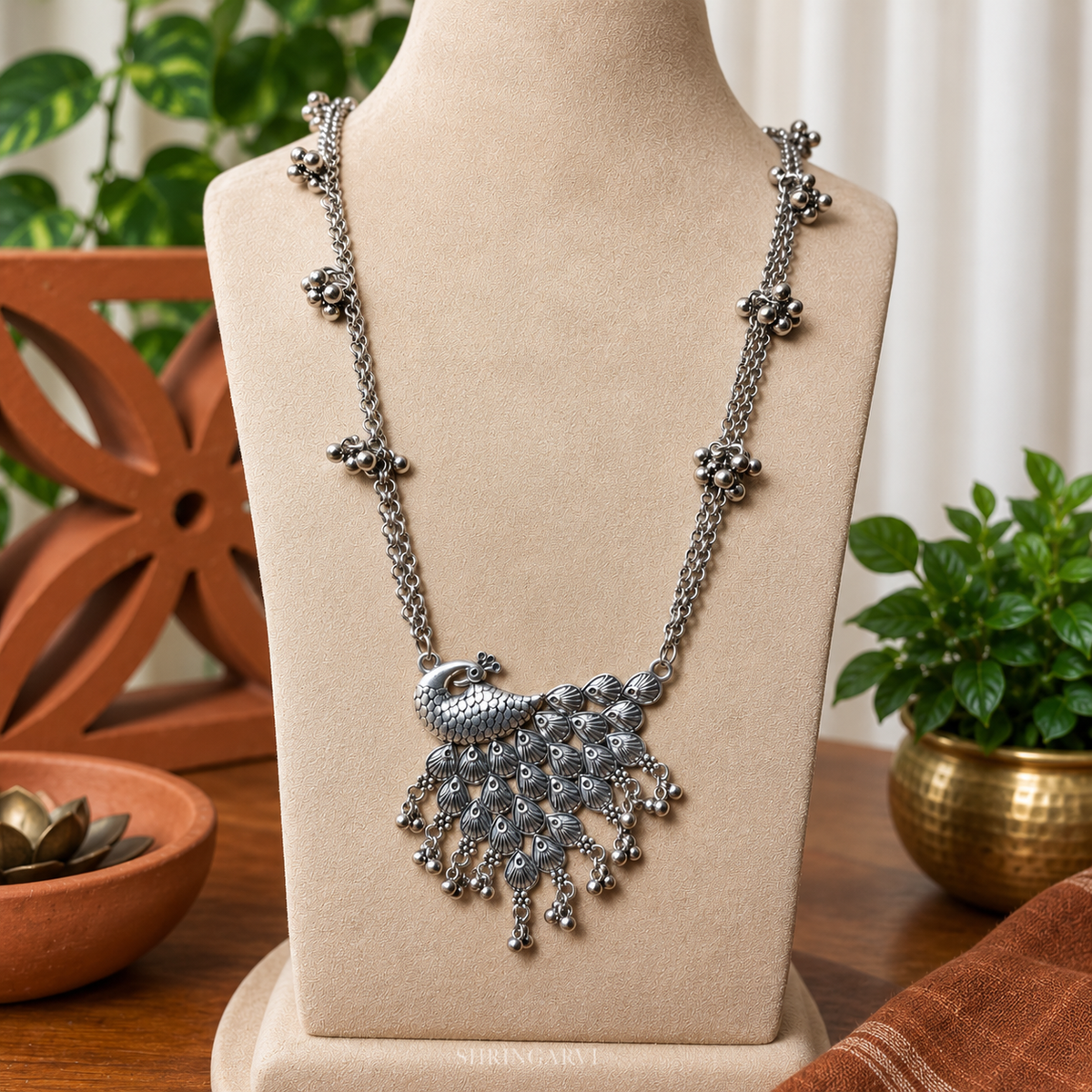 Oxidized silver peacock necklace for women, handcrafted tribal statement necklace with ghungroo detailing, long ethnic necklace styled with traditional Navratri Garba outfit.