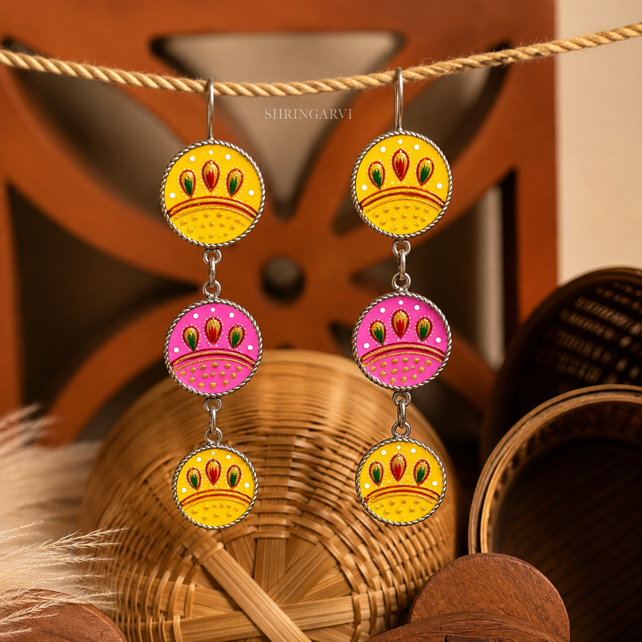 Yellow-Pink Kyari Danglers in oxidised brass with handpainted yellow and pink enamel detailing and three-tier boho design.